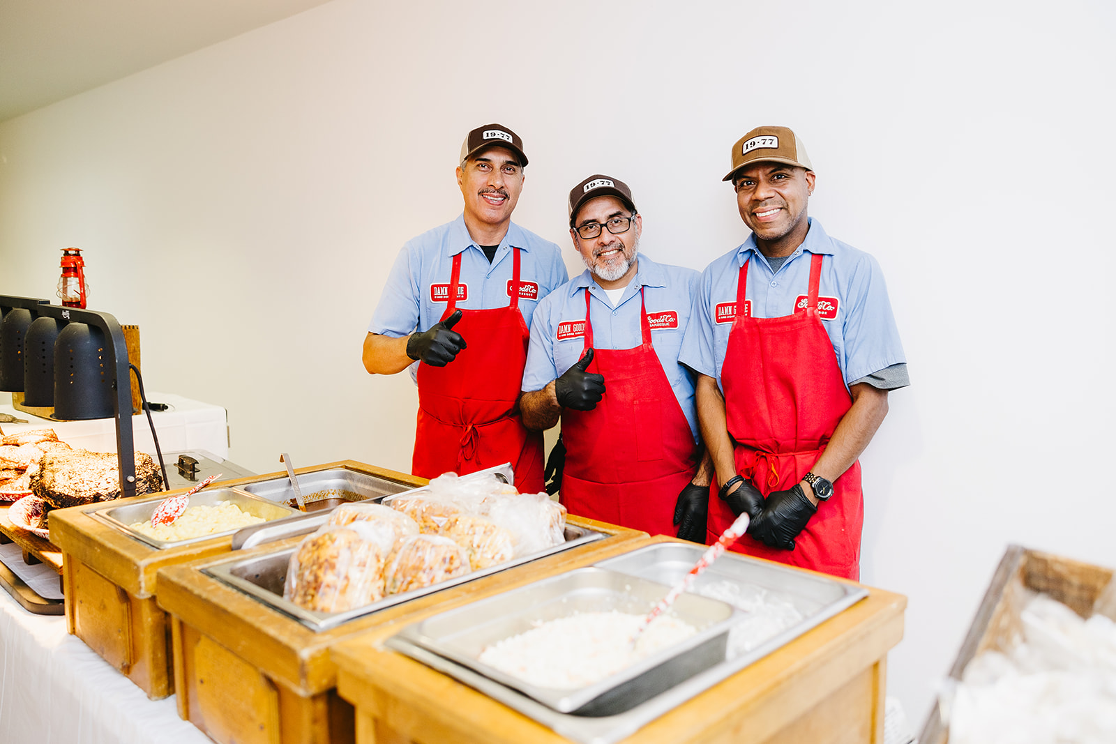 Goode Co Team Hard at Work at Corporate Catering Events Wearing Red Aprons