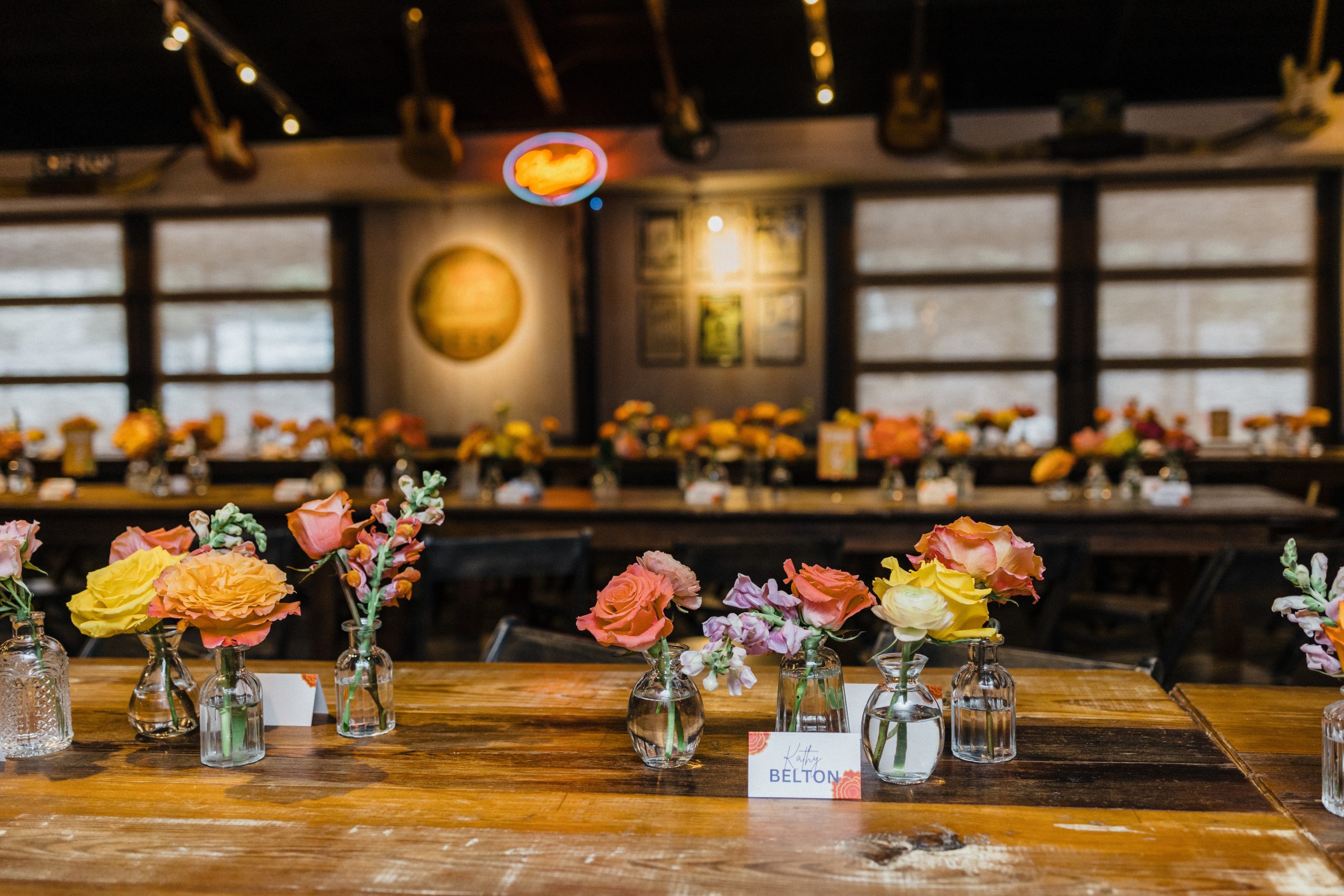 Flower Arrangement Placed on Wooden Tables for Luxury Private Event by Goode Co. Catering