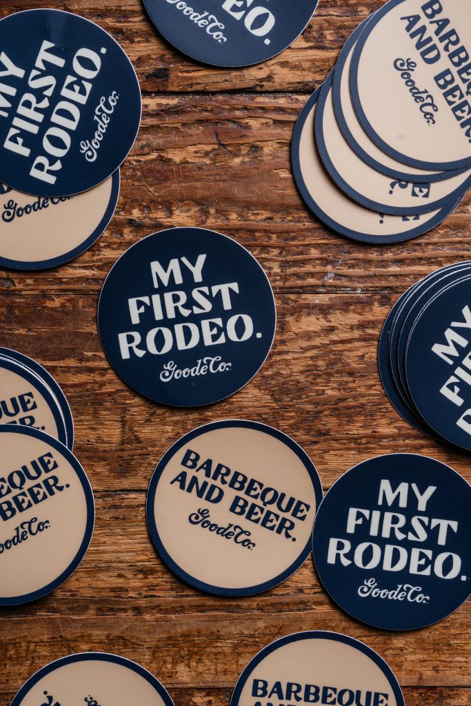 Drink coasters that read ‘Barbeque and Beer, Goode Co’ or ‘My first rodeo Goode Co.’