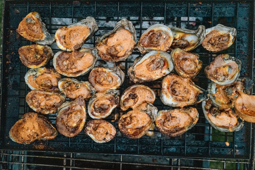 Oysters being grilled on the BBQ.